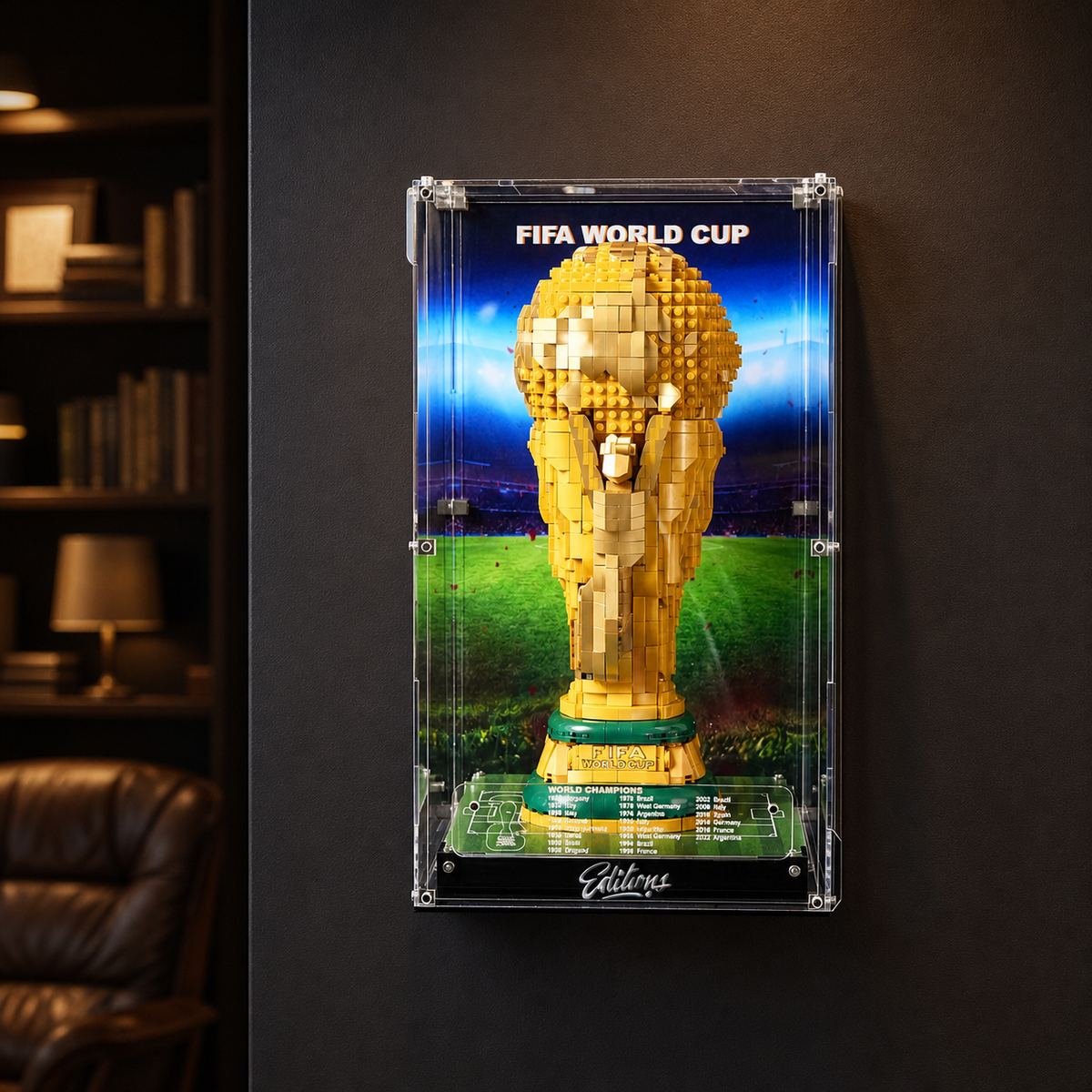 LEGO FIFA World Cup Trophy mounted in a wall-mount display frame with LED lighting on a dark feature wall