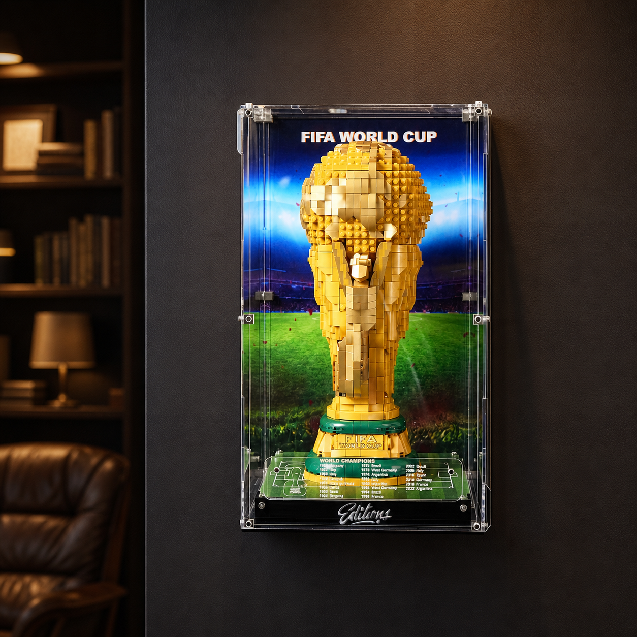 LEGO FIFA World Cup Trophy mounted in a wall-mount display frame with LED lighting on a dark feature wall
